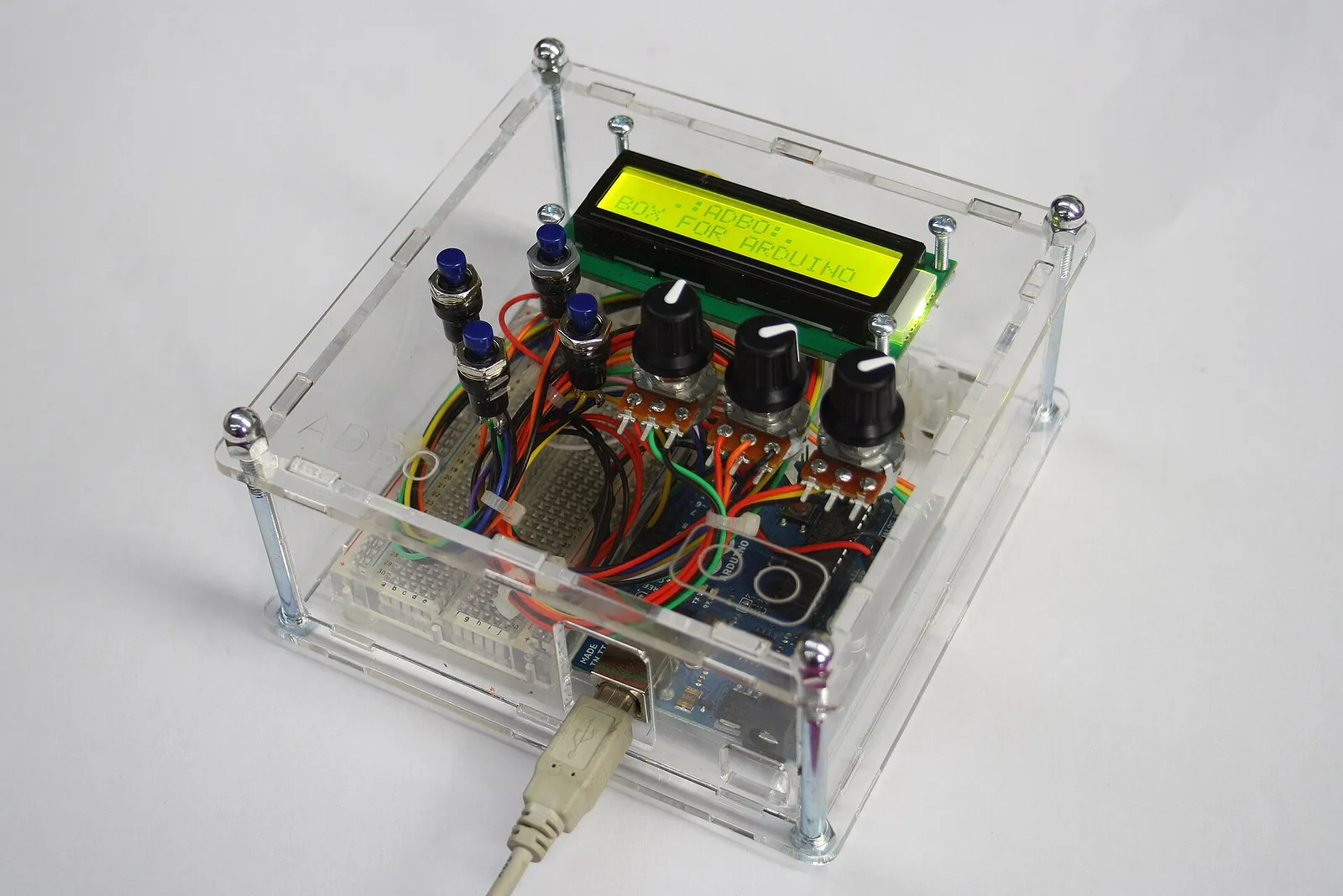 A clear acrylic project box, held together with standoffs, housing an Arduino board, a display and control knobs